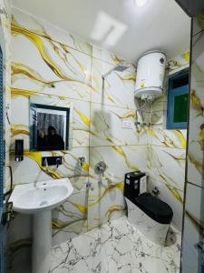 a bathroom with a sink and a toilet at Gulmarg serenity in Khor