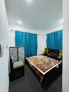 a bedroom with a bed and a chair in it at Gulmarg serenity in Khor