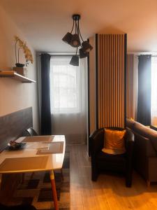 a living room with a couch and a table at Apartmán CENTRAL, free parking in Banská Bystrica