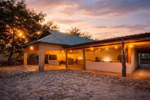 a house with a stone driveway in front of it at Voyager's Center in Kikorongo