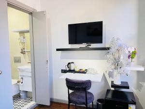a room with a chair and a tv on a wall at Rovigo Hotel in Istanbul +103 photos