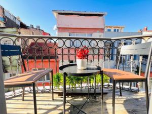 a table with a vase of flowers on a balcony at Rovigo Hotel in Istanbul