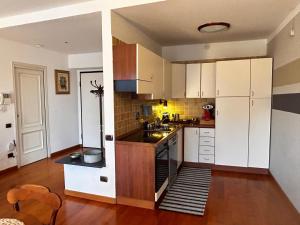 a kitchen with white cabinets and a counter top at Il re di Torino in Turin