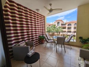 a patio with a table and chairs on a balcony at Queens gardens in Paphos