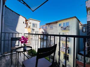 a balcony with a table and a vase of flowers at Rovigo Hotel in Istanbul