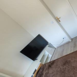 a flat screen tv on the wall of a room at OneRoomStay in Delmenhorst