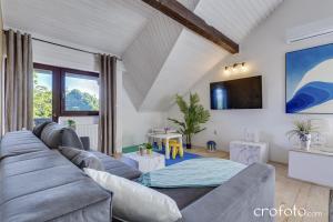 a living room with a couch and a tv at Apartments Villa Mavi in Plitvička Jezera