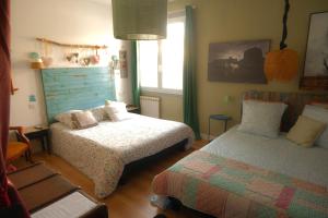 a bedroom with two beds and a window at La Norélie in Saint-Sulpice-de-Royan +45 photos