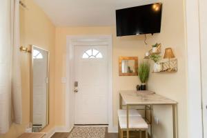 a bathroom with a desk and a white door at Chic Groton Studio • A Cozy, Modern & Central Gem in Groton