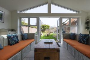 a living room with two couches and a table at Haven House in Lymington