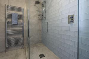a shower with a glass door in a bathroom at Haven House in Lymington +43 photos