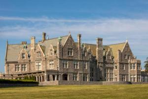 an old castle with a grassy field in front of it at Chic Groton Studio • A Cozy, Modern & Central Gem in Groton