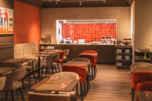 a restaurant with tables and chairs and a counter at Prado Next Door in Ostend