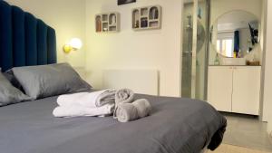 a bedroom with a bed with towels on it at Le Talantueux in Talant