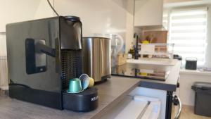 a kitchen with a counter with a coffee maker on it at Le Talantueux in Talant