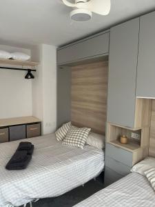 a bedroom with two beds and a large mirror at Apartamento con WiFi y Aire acondicionado en Pals Playa in Pals +36 photos
