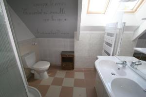 a bathroom with a toilet and a sink at Gite de la Mare de la Trémaillerie in Blainville-sur-Mer +10 photos