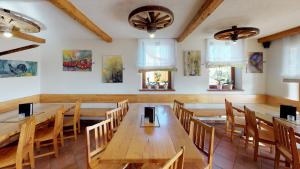 a dining room with wooden tables and chairs at Urlaub am Weinhof Ramminger in Gleisdorf