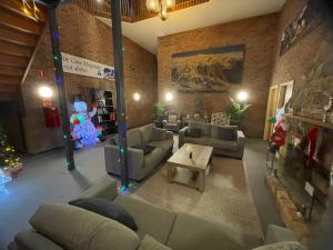 a living room with couches and a christmas decoration at Alpine Gables Apartment in Jindabyne +1 photo