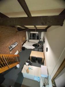 an overhead view of a room with a bed and a couch at Alpine Gables Apartment in Jindabyne