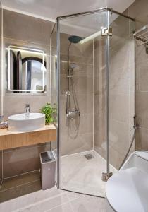 a bathroom with a shower and a sink at Jan Casa in Ho Chi Minh City +22 photos