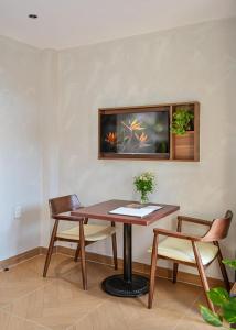 a table and chairs in a room with a tv at Jan Casa in Ho Chi Minh City