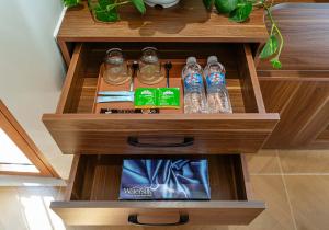 a wooden cabinet with bottles of water in it at Jan Casa in Ho Chi Minh City