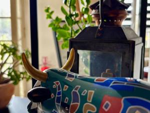 a vase with horns and a statue of a bull at Gabriel Hotel Chinon in Chinon