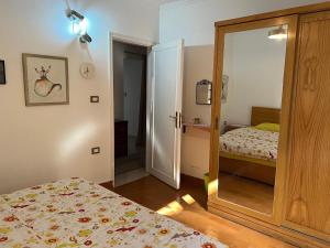 a bedroom with a bed and a door with a mirror at Maison de Lama - Expat friendly, AirCon, Garden access in Cairo