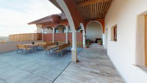 a patio with a table and benches on a building at Urlaub am Weinhof Ramminger in Gleisdorf
