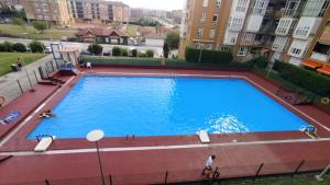 an overhead view of a large swimming pool in a apartment at GRAN FAMILIA in Santander