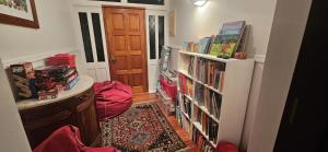 a hallway with a book shelf filled with books at FOREST WATERS in Haruru