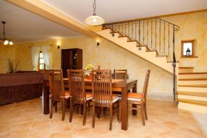 a dining room with a table and chairs and a staircase at Villa Vernier by IstriaLux in Kringa