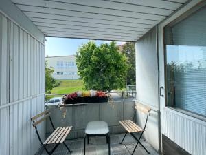 two chairs sitting on a balcony with a window at Savonlinna City Apt Central in Savonlinna