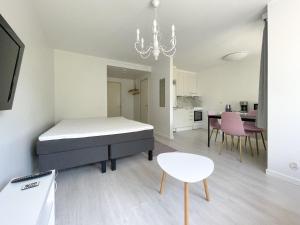 a bedroom with a bed and a table and chairs at Savonlinna City Apt Central in Savonlinna