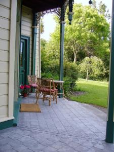 a patio with a table and chairs on a house at Forest Manor in Geraldine