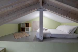 a bedroom with a large bed in an attic at Panorama City Loft in Mytilene