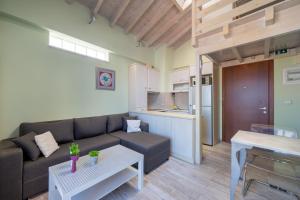 a living room with a couch and a table at Panorama City Loft in Mytilene