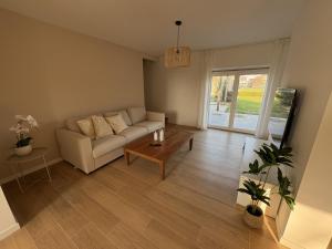 a living room with a couch and a table at De Boomgaard in Nieuwerkerken