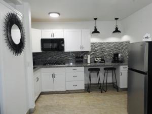 a kitchen with white cabinets and a stainless steel refrigerator at AWESOME PLACe in Las Vegas
