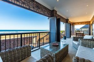 a balcony with a view of the ocean at Seemeeu, Gouritsmond in Gouritzmond