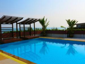 a swimming pool on the roof of a building at AG Property in Mae Pim