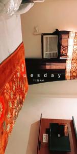 a room with a bed with a radio on a shelf at SGroom in Amritsar