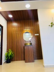a wooden door in a hallway with a potted plant at The Hampiness Studio 2 in Hospet