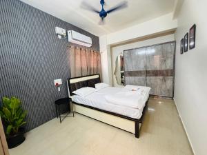 a bedroom with a large bed in a room at The Hampiness Studio 2 in Hospet +10 photos