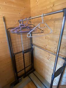 a metal rack in a room with a wooden wall at Chalet de Bazas in Bazas