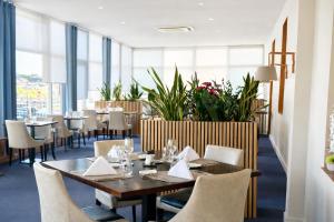a dining room with a table and chairs at Le Grand Hôtel de Mayenne - Logis hôtels restaurant in Mayenne