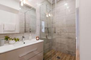 a bathroom with a shower and a white sink at Totolulu Cannes Luxury Properties in Cannes