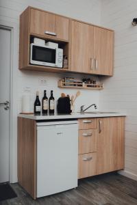a kitchen with a white refrigerator and a microwave at Fanarele din Hangu in Hangul +16 photos