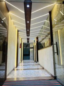 an empty hallway in a building with a ceiling at hotel shree palace in Ratlām